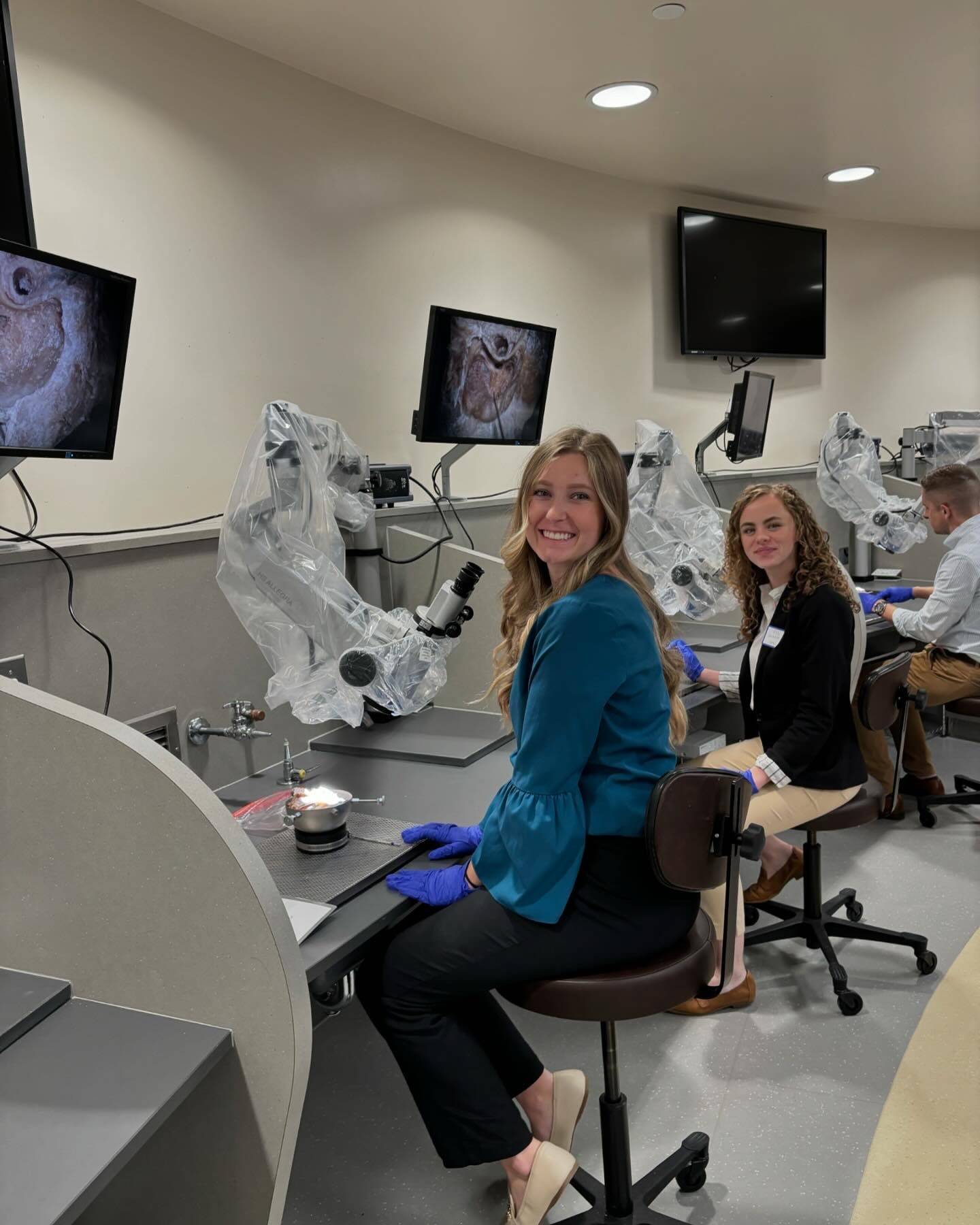 Audiology Student using microscope at MEI conference